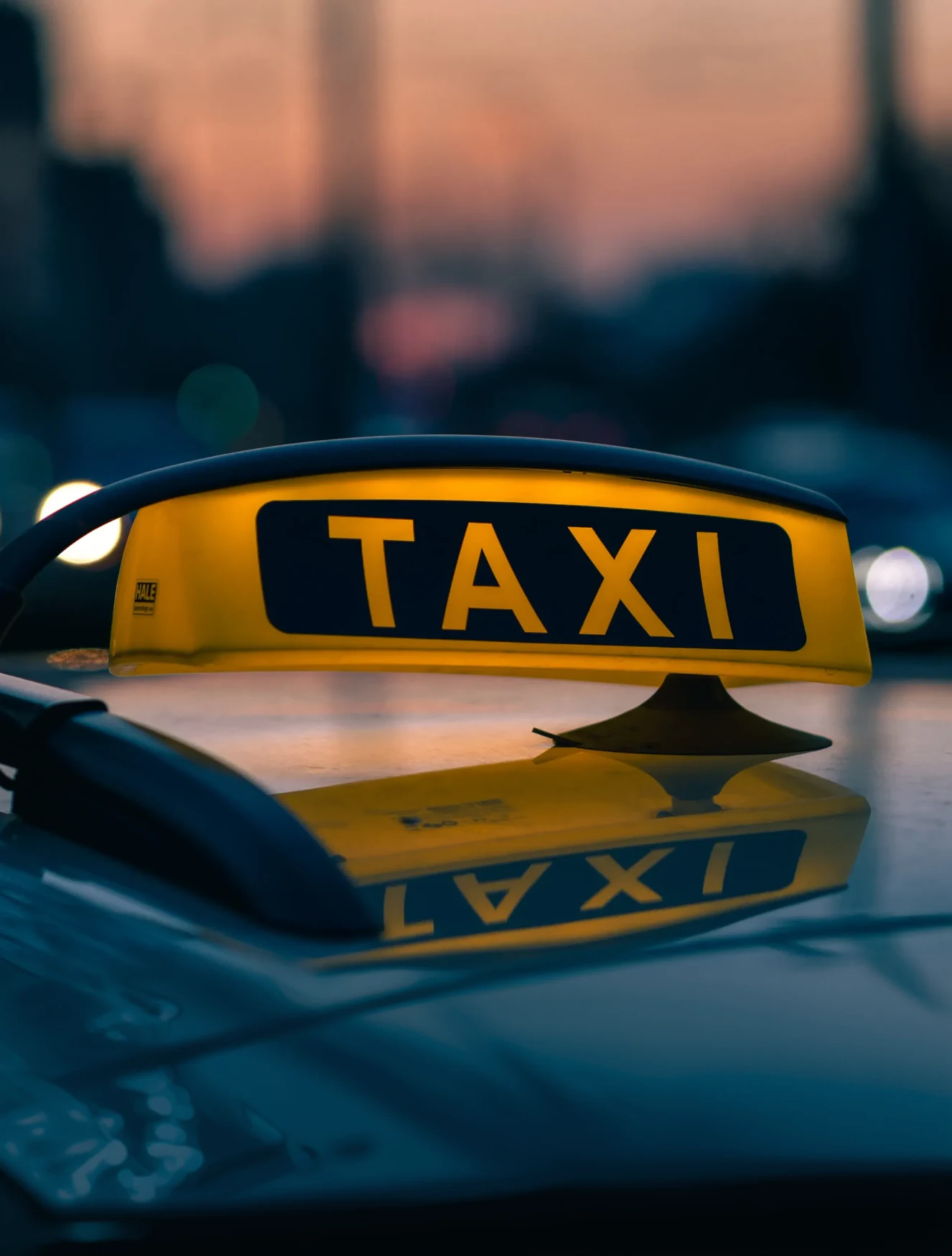 Two people sitting at a table with a laptop.