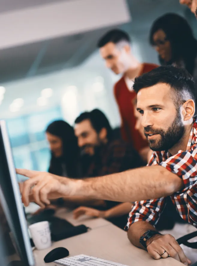 Two people sitting at a table with a laptop.