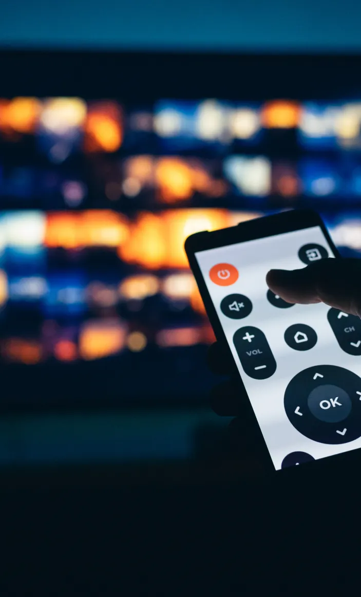 Two people sitting at a table with a laptop.