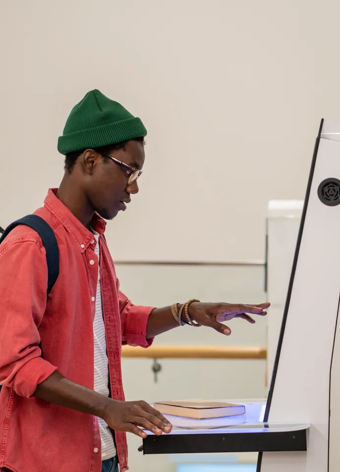Two people sitting at a table with a laptop.