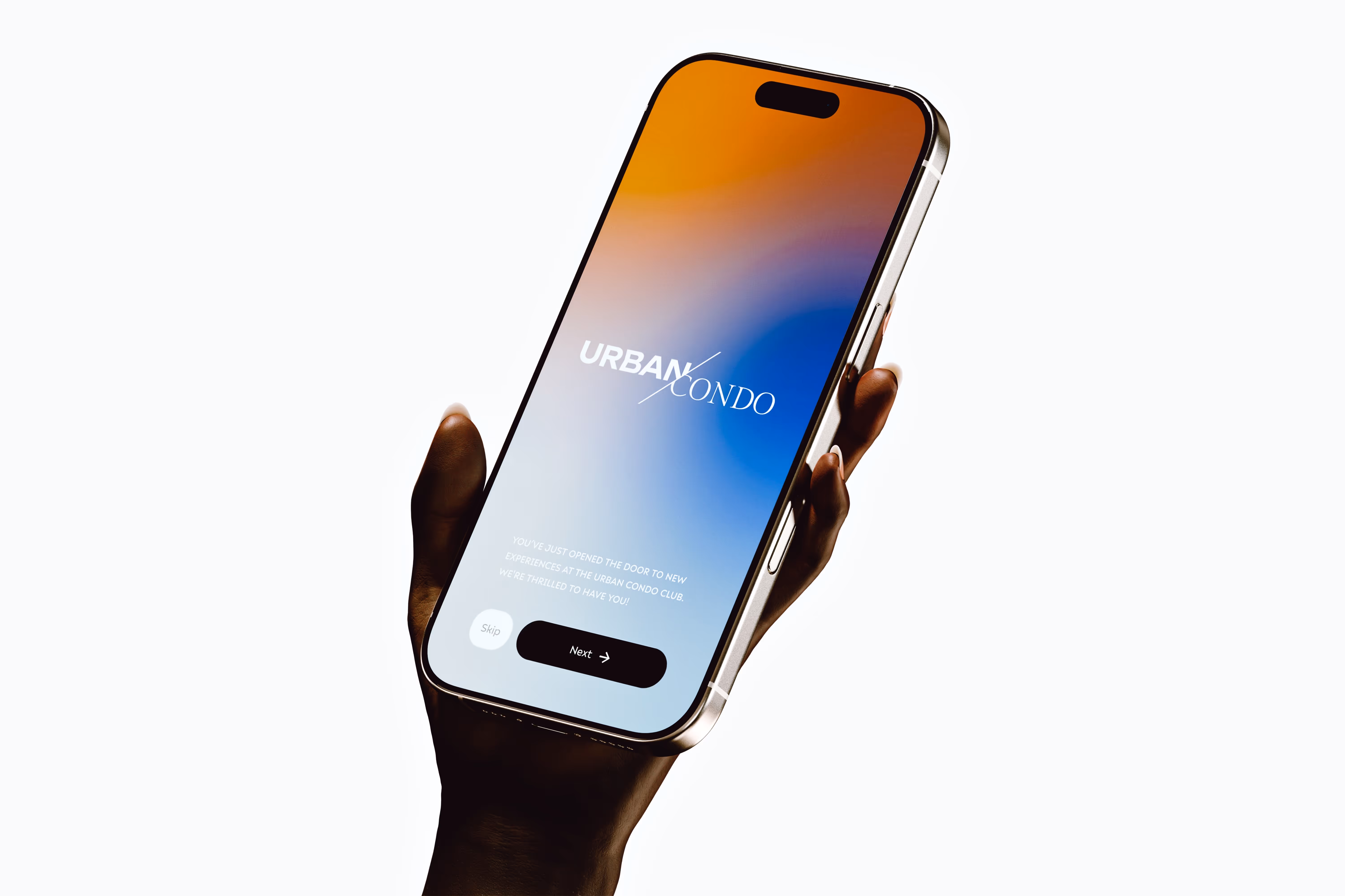 Hand holding a smartphone displaying a welcome screen for Urban Condo with Skip and Next buttons.