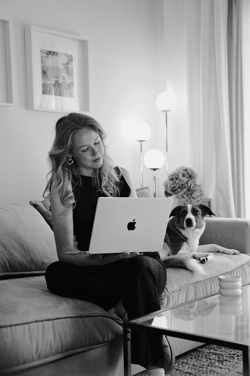 Founder of Red Snow Studio working from a sofa with a laptop in a relaxed environment
