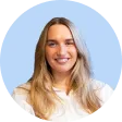 Portrait of a smiling young woman with long blonde hair wearing a white shirt, set against a light blue circular background.