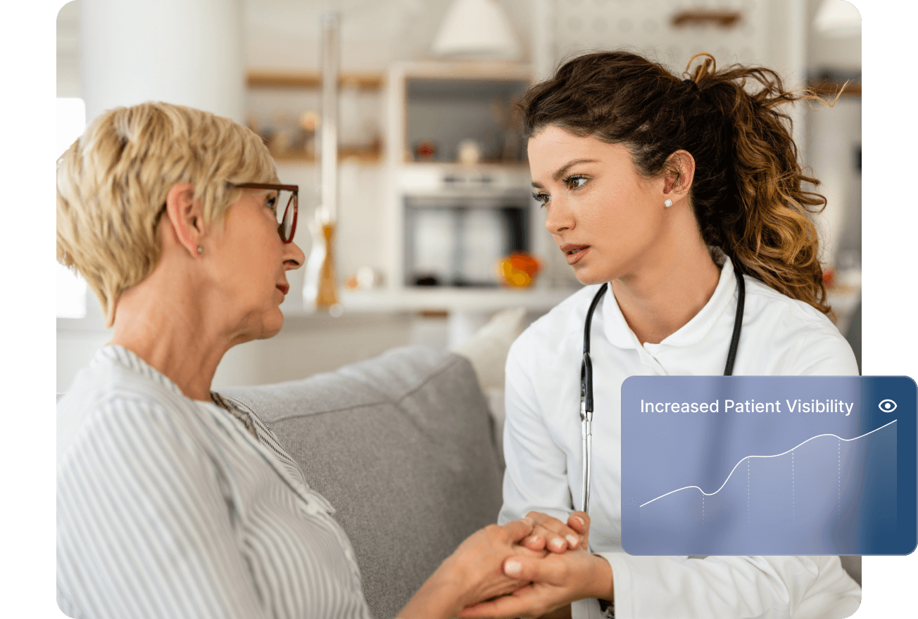 Smiling male doctor in blue scrubs with a stethoscope working on a laptop at a desk.