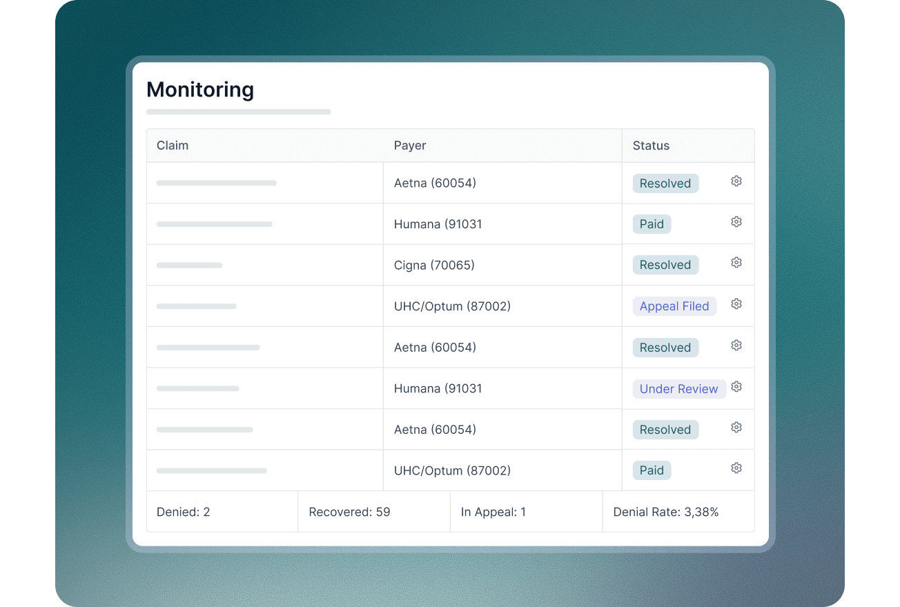 Smiling male doctor in blue scrubs with a stethoscope working on a laptop at a desk.