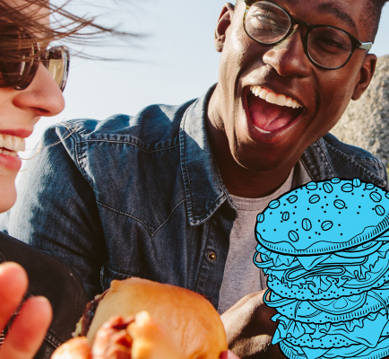 Two people smiling and enjoying burgers outdoors with a blue cartoon burger graphic overlay.