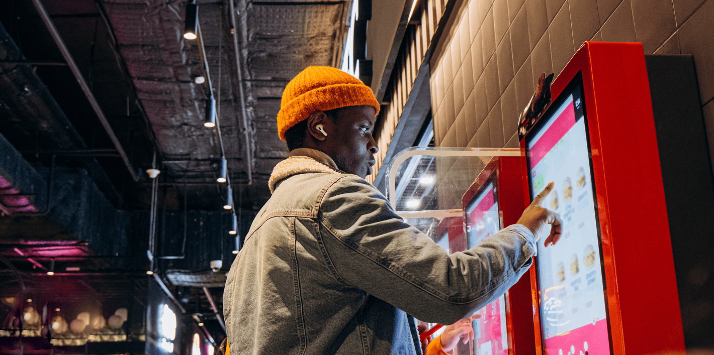 Stock image of a man at an ordering kiosk
