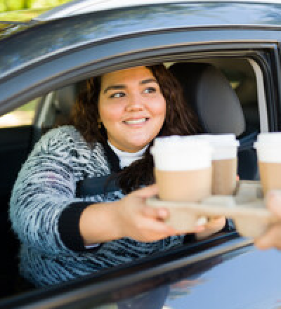 coffee delivery in a car window
