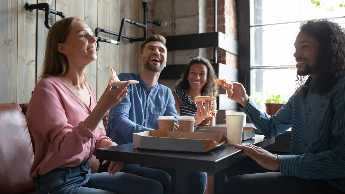 Stock image of people at a table ordering food