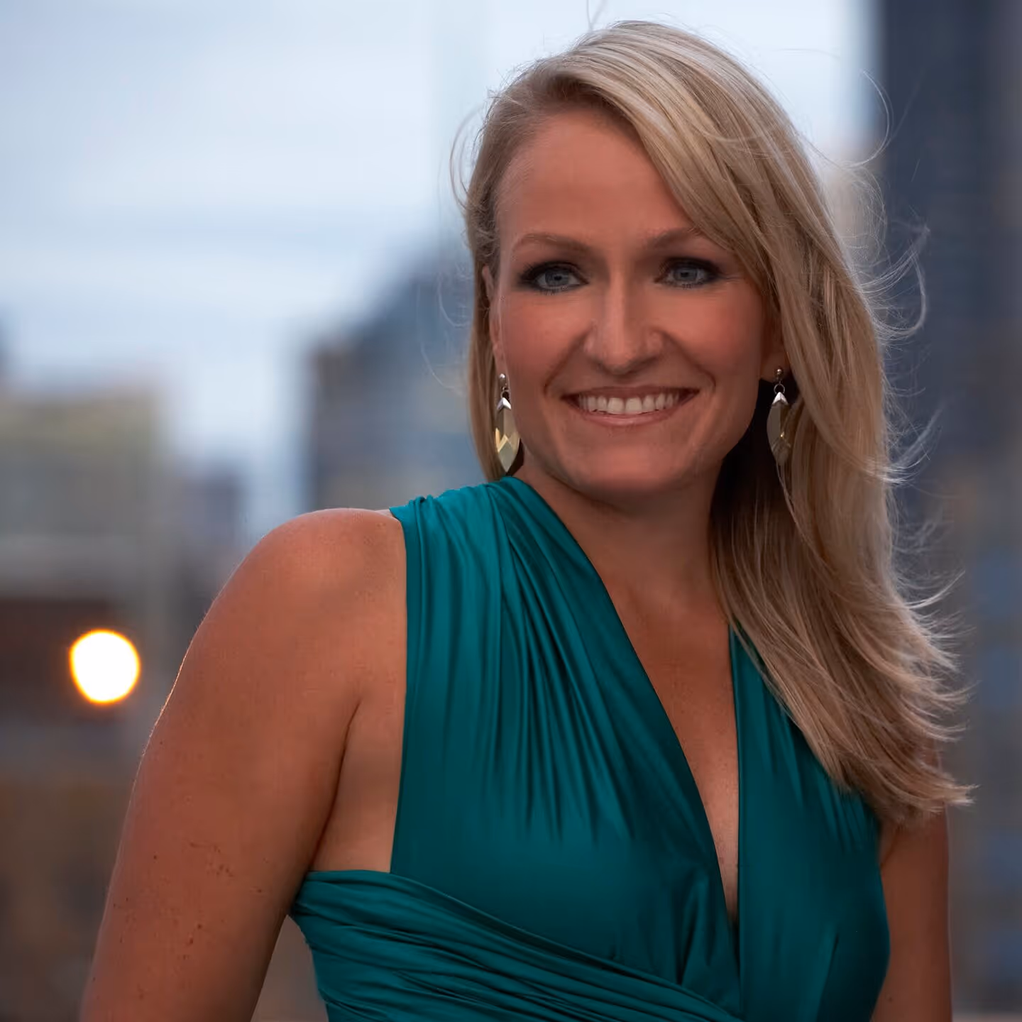 Man intensely playing a marimba with four mallets in an ornate room with decorative wallpaper and architectural details.