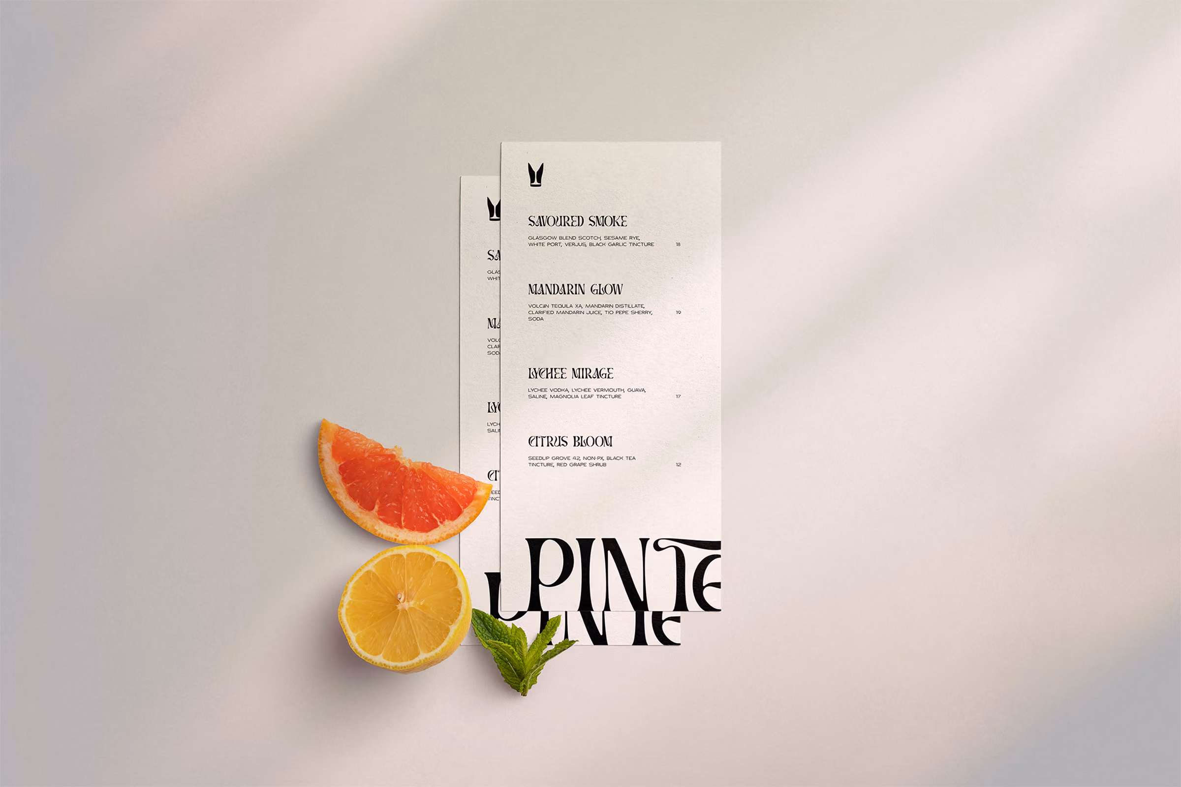 Pinte cocktail menu with slices of grapefruit and lemon