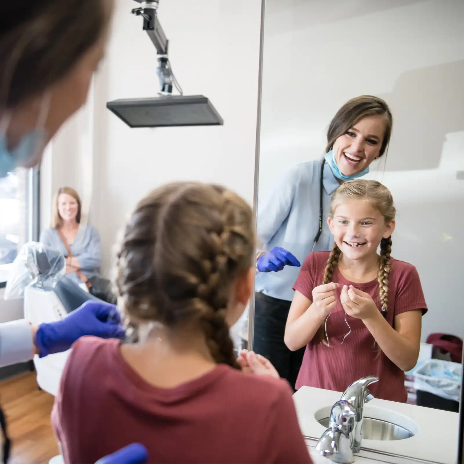 A child smiling happily during a comfortable dental visit at Tranquility Dental Wellness in Tumwater, WA.