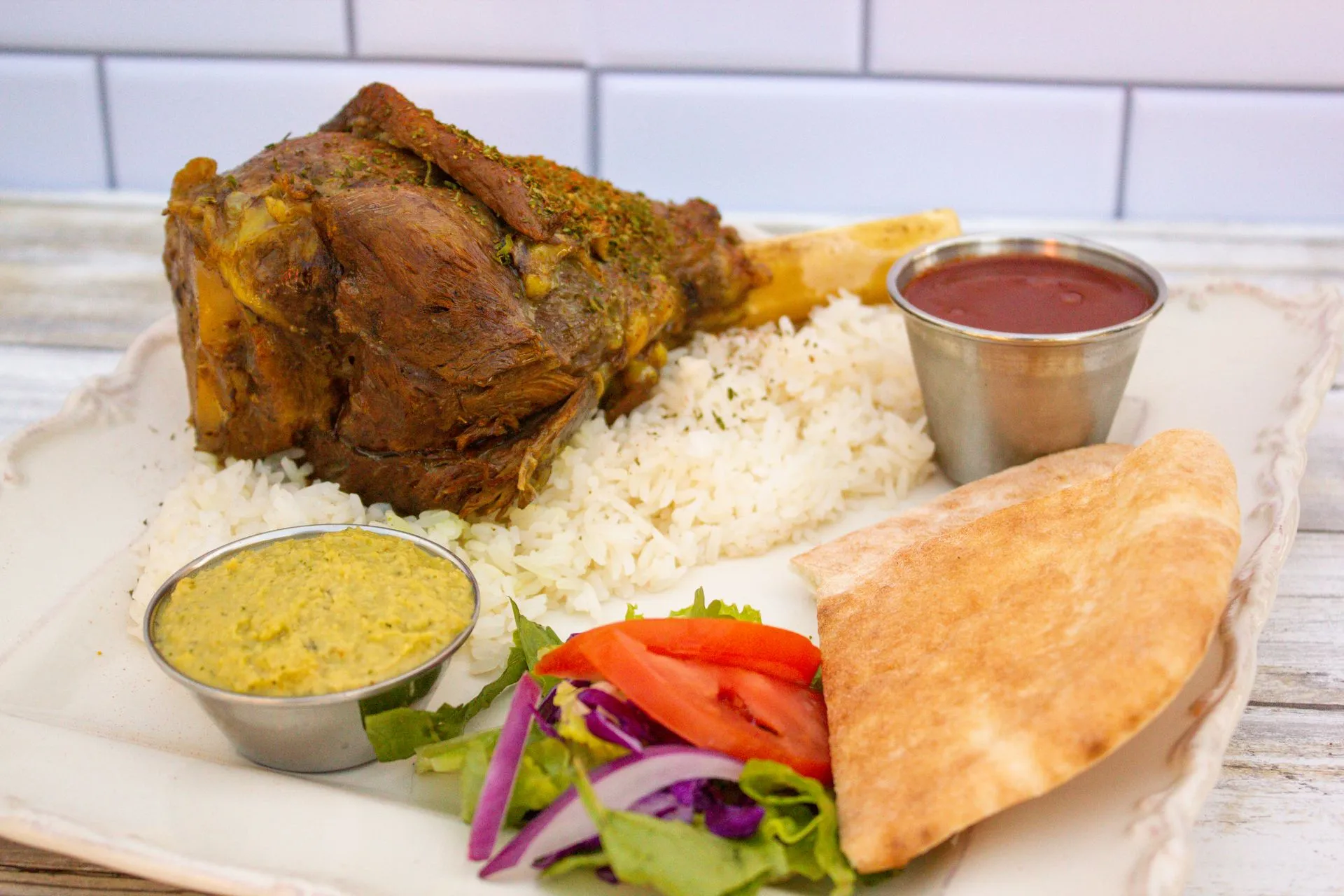 A plate of food with rice, meat, and vegetables.