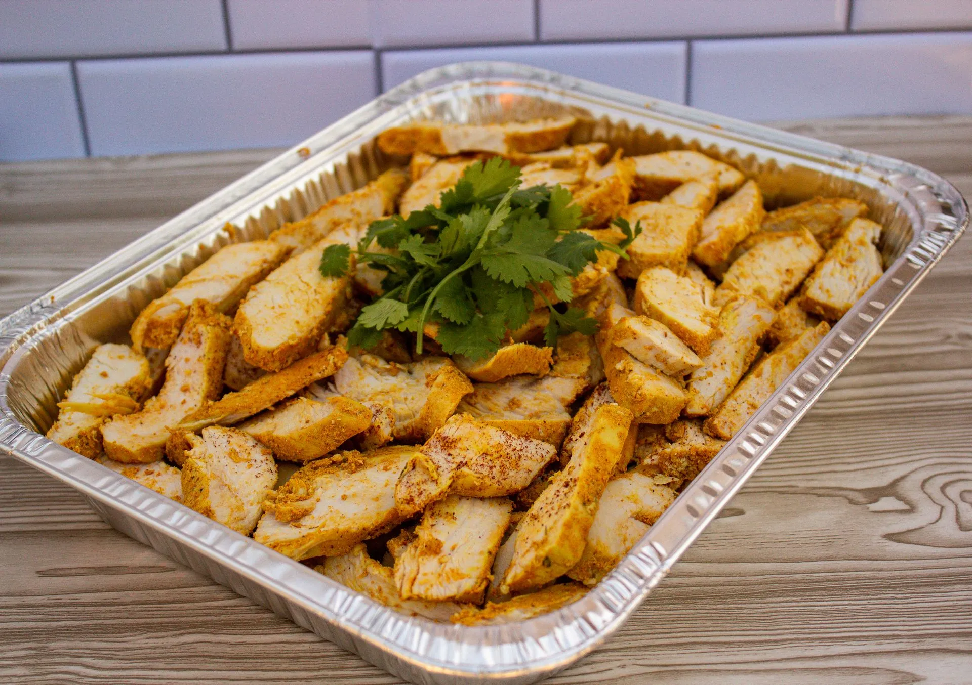 A tray of food with a green garnish on top.