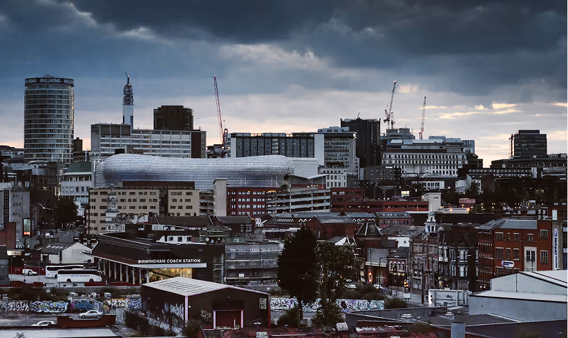 Birmingham city skyline with dramatic cloudy sky and urban buildings