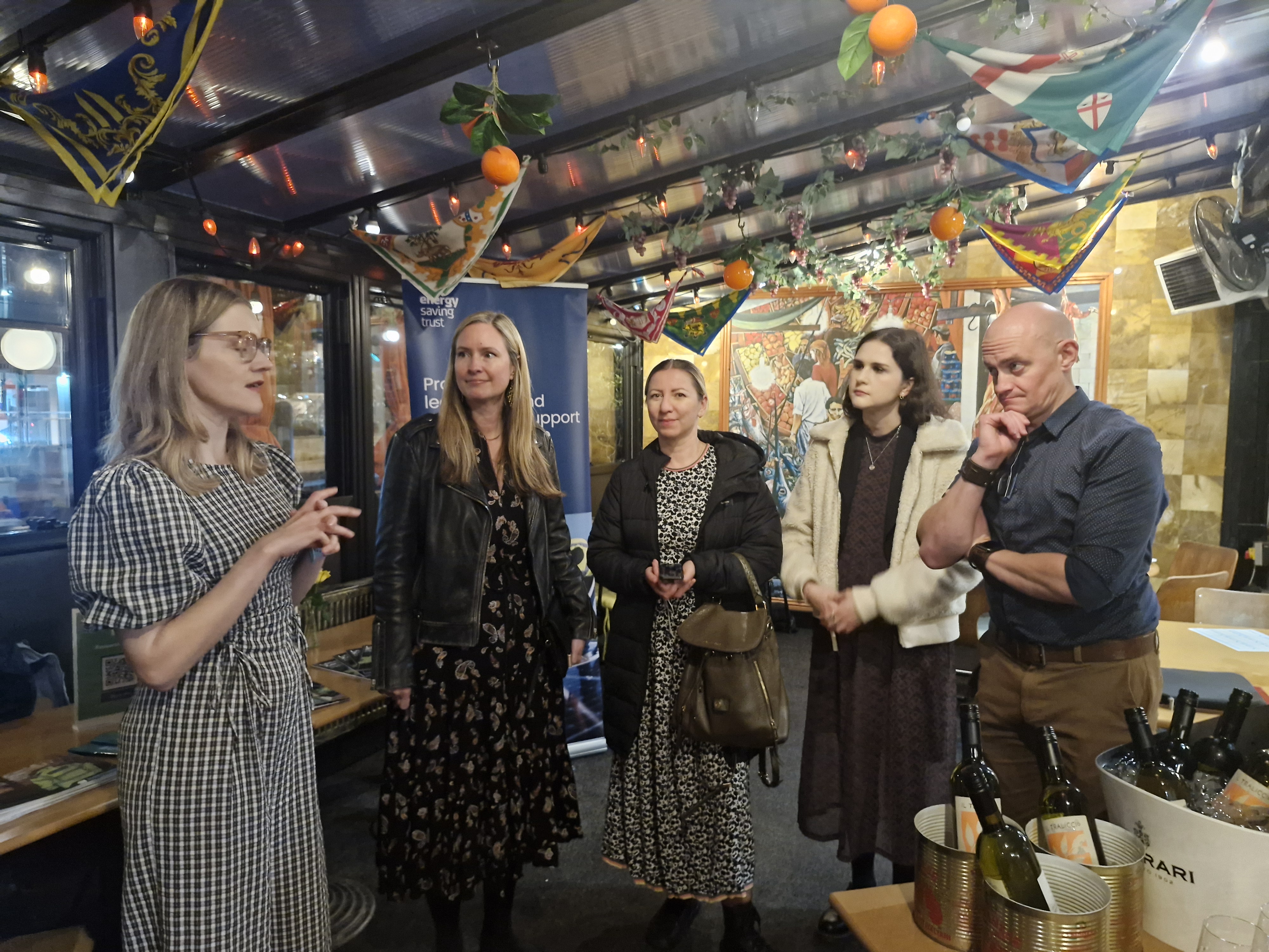 Group of people gathered at an event with Energy Saving Trust banner