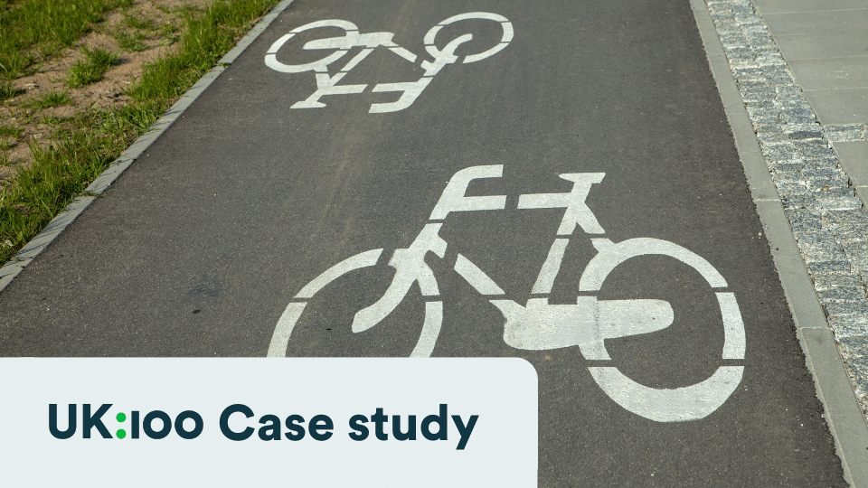 Dedicated bicycle lane with white bike symbols painted on asphalt path