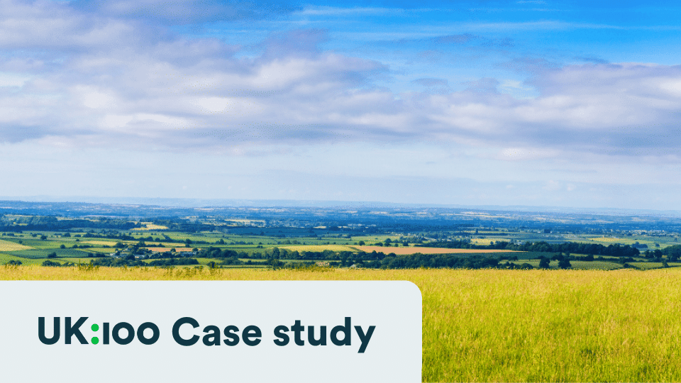 Expansive British countryside with green fields and blue sky
