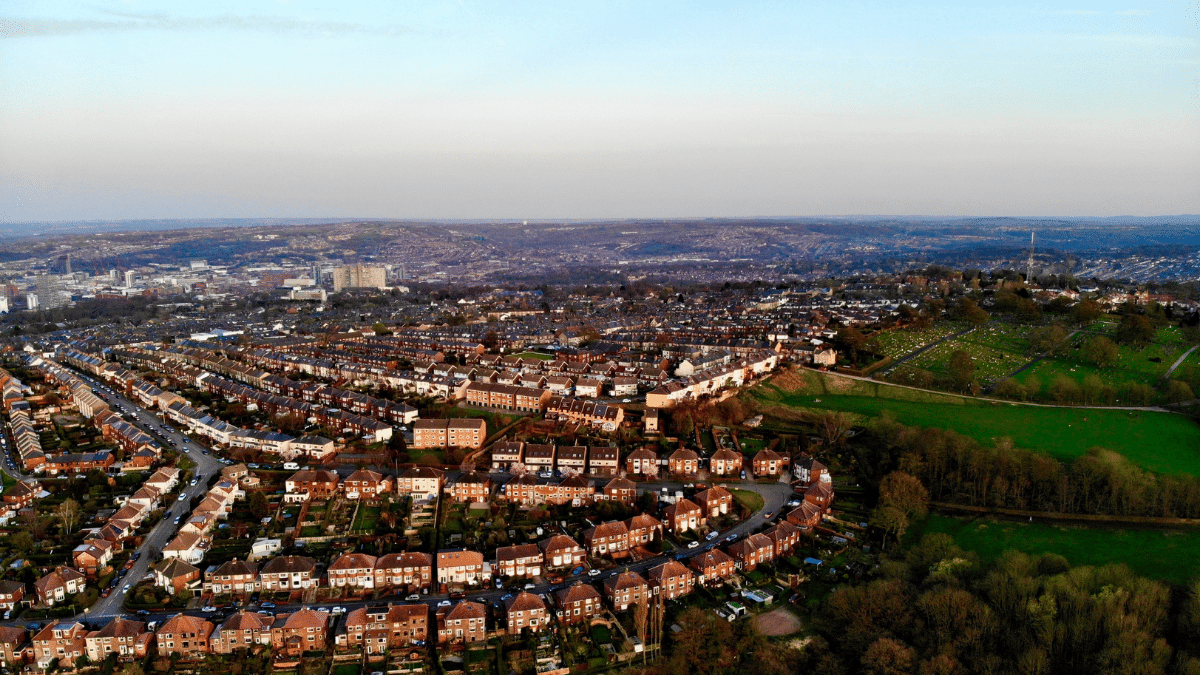 Aerial view of suburban neighborhood with rows of red brick houses