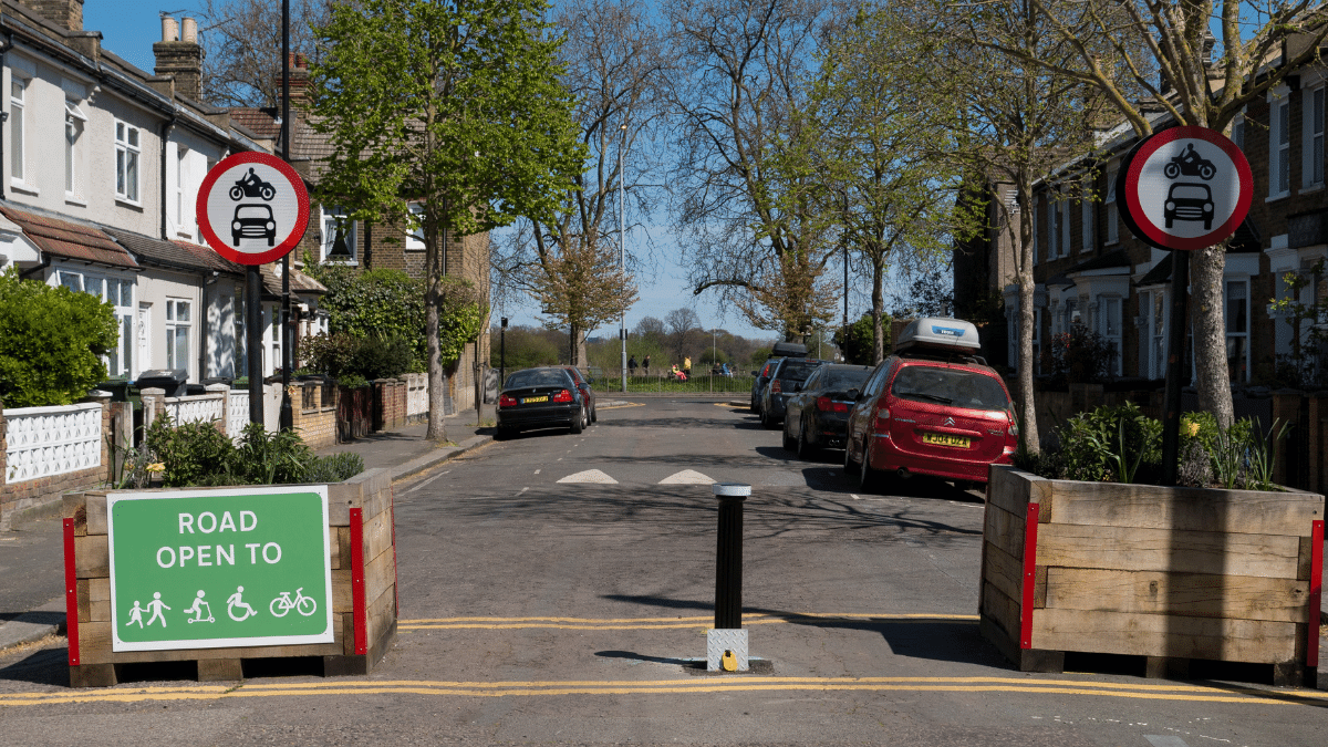 Neighborhood street with traffic signs showing road open to pedestrians and cyclists