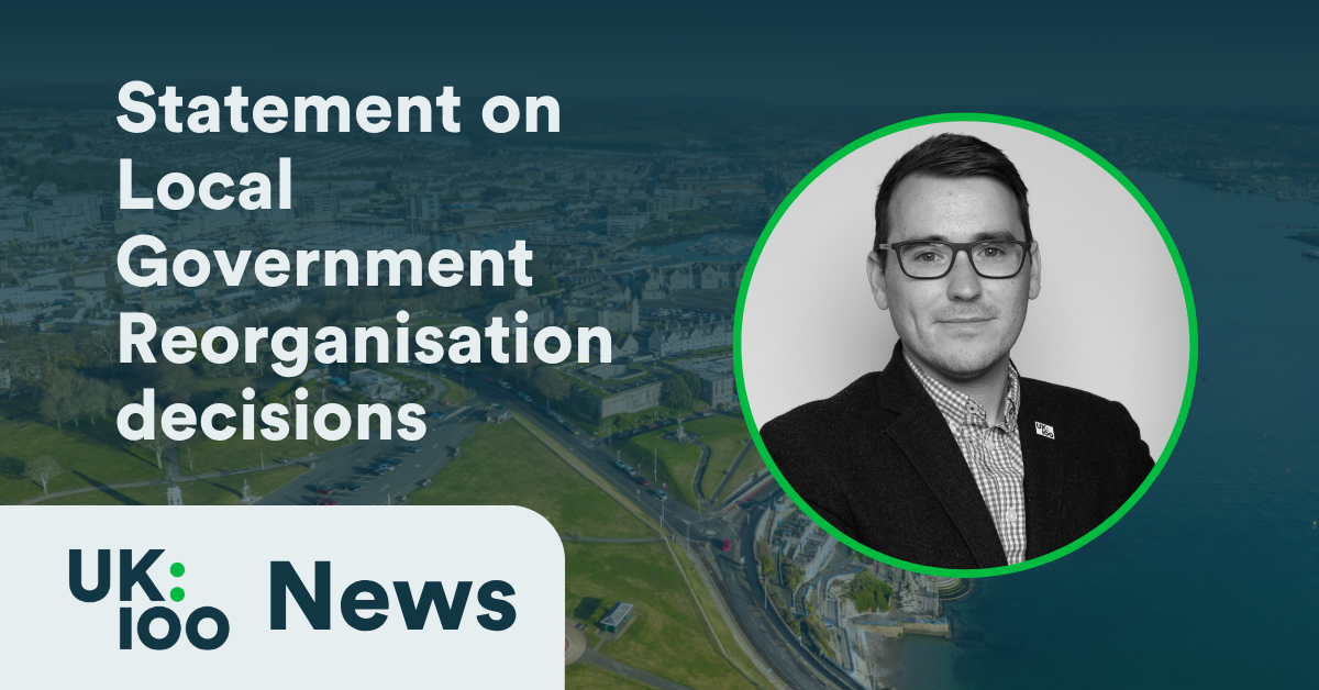 UK100 News graphic reading "Statement on Local Government Reorganisation decisions" with a black and white headshot of chief executive Christopher Hammond against an aerial coastal cityscape.