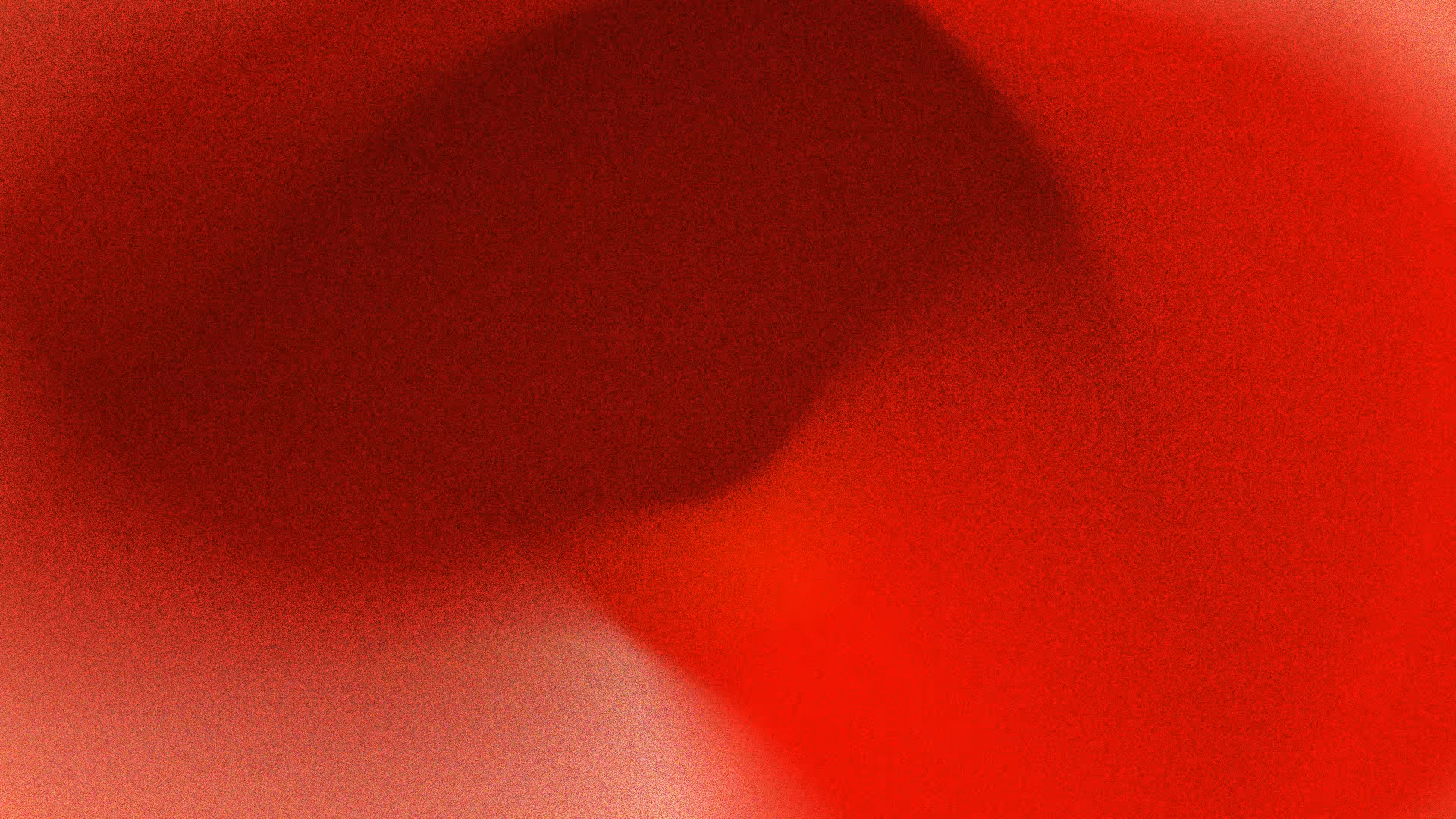 Abstract image with a gradient of dark red to bright red shades.