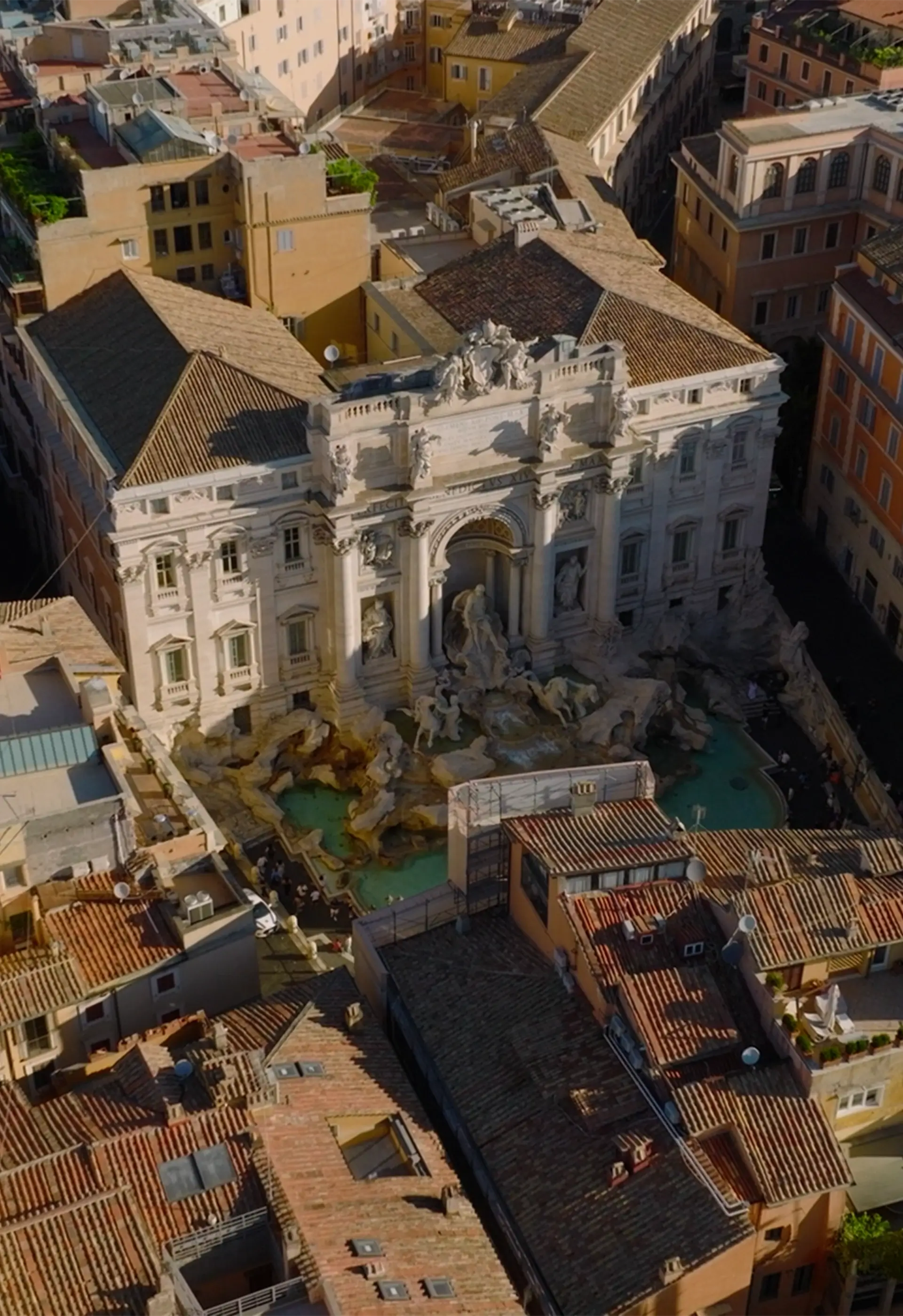 Aerial view of the Trevi Fountain with surrounding old buildings in Rome, Italy.