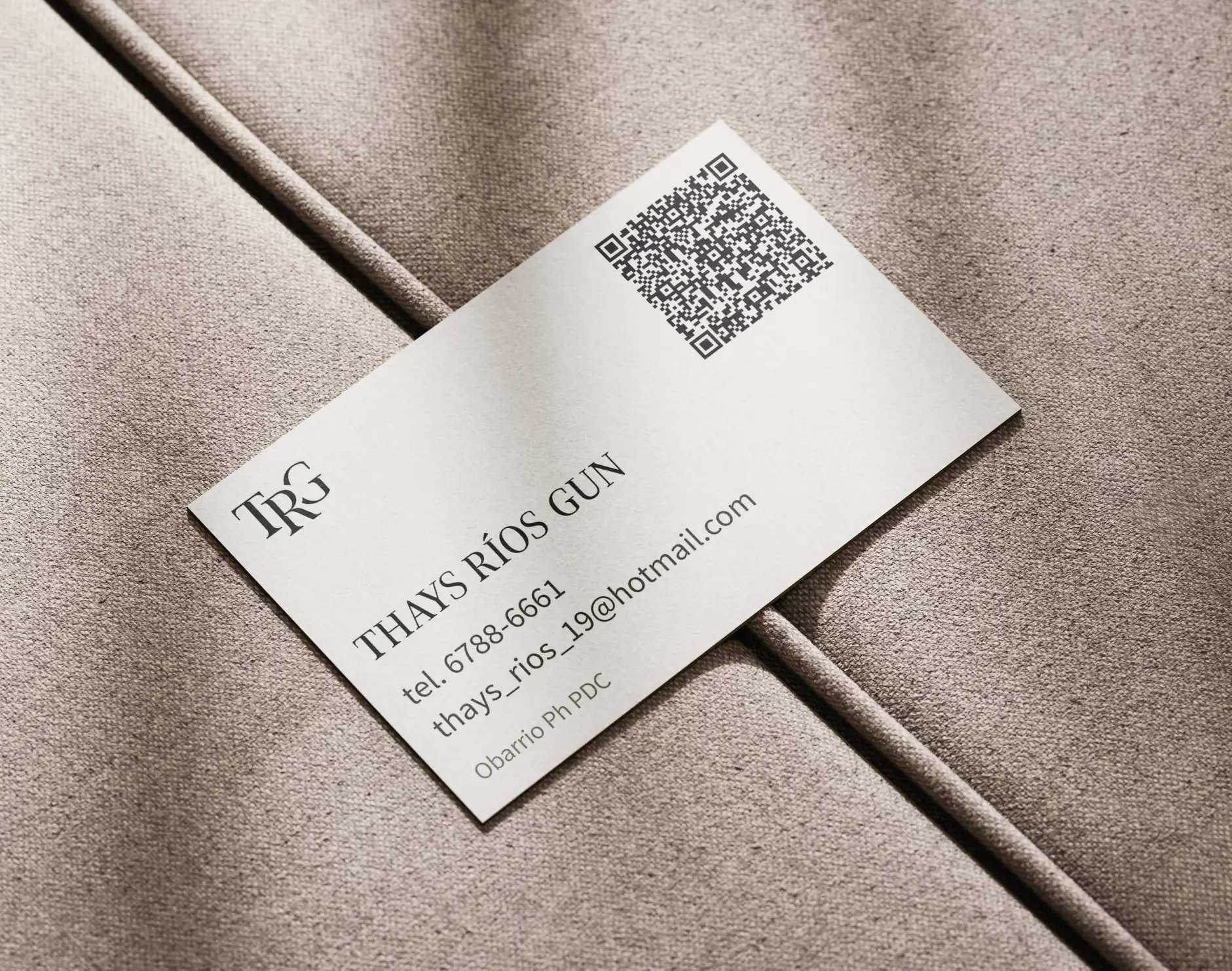 White legal business card template displaying the TRG monogram contact details and a digital QR code over a textured beige couch.