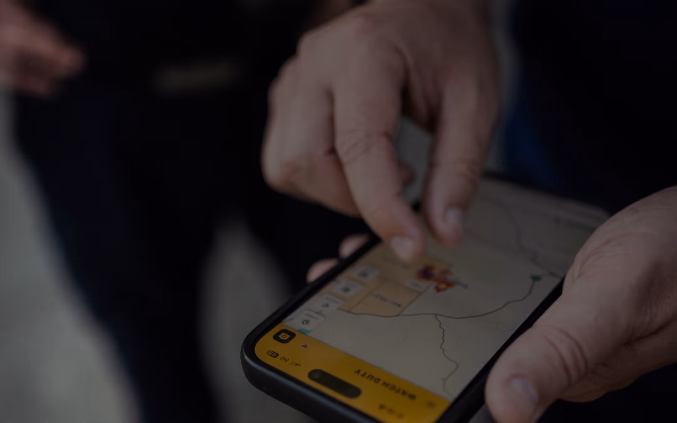 Person using a smartphone with a map and location markers displayed on the screen.