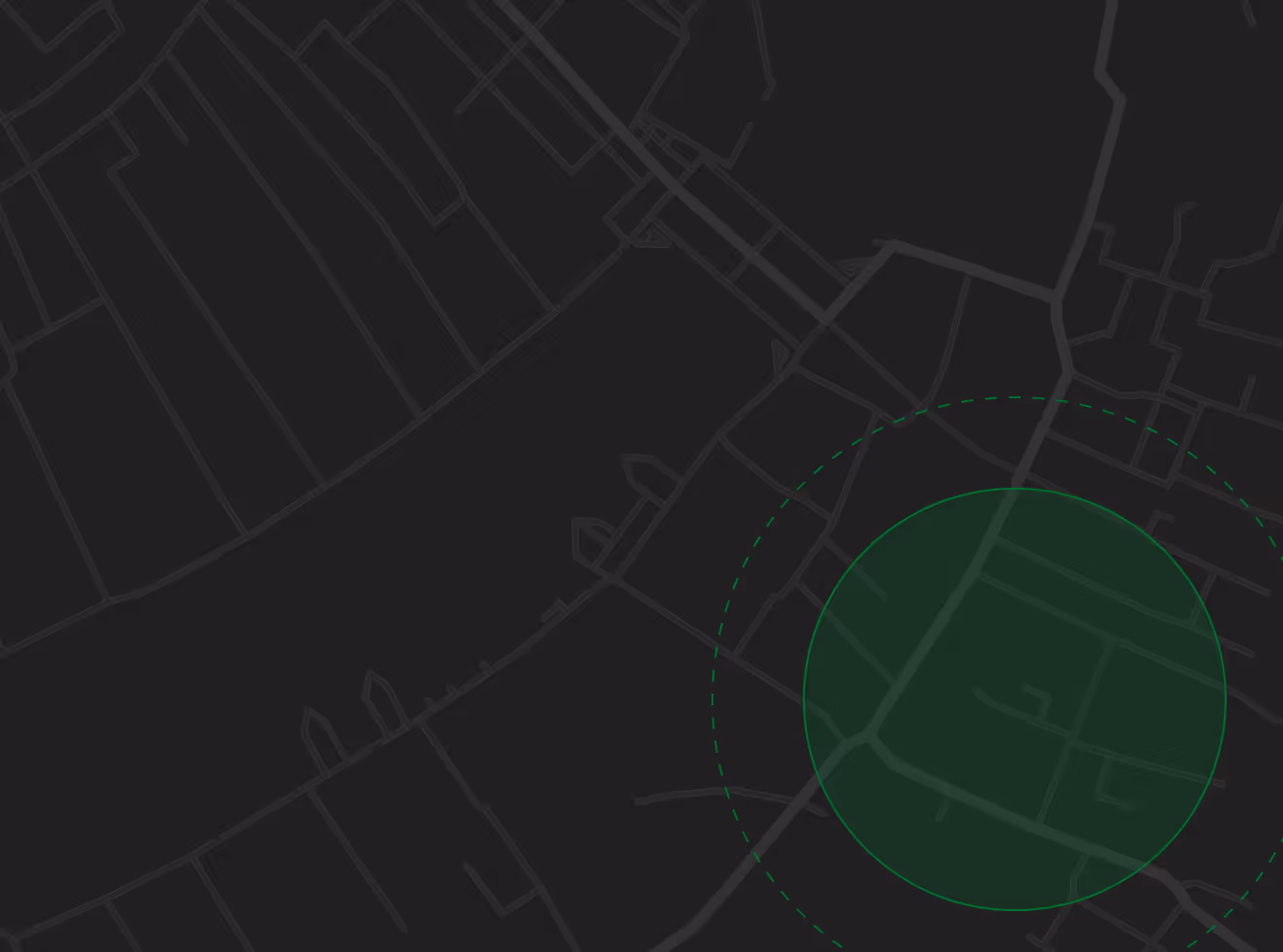 Dark map with faint street lines and a green circular area highlighted in the lower right section.