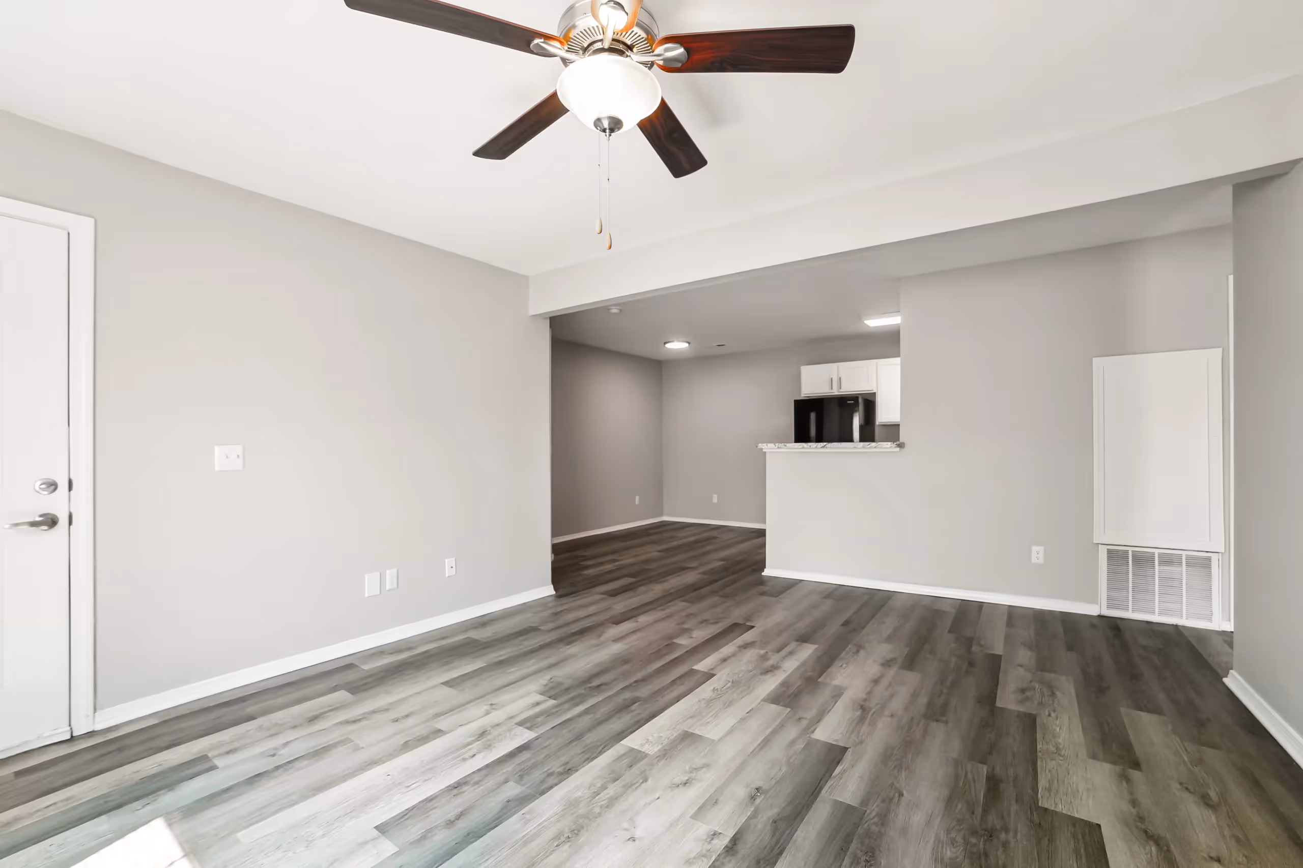 unfurnished living area with fireplace and view of kitchen