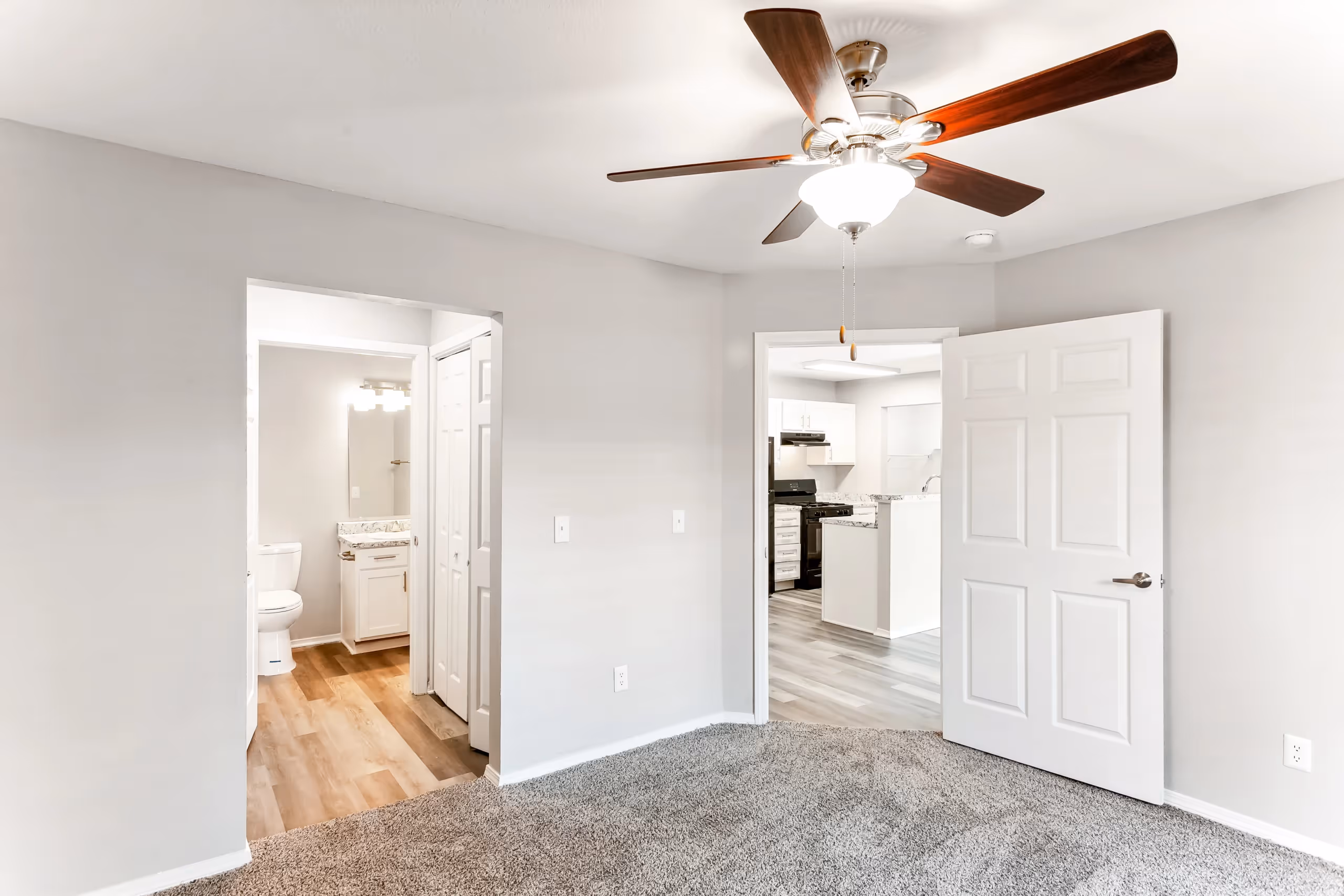 unfurnished bedroom with view of bathroom and kitchen