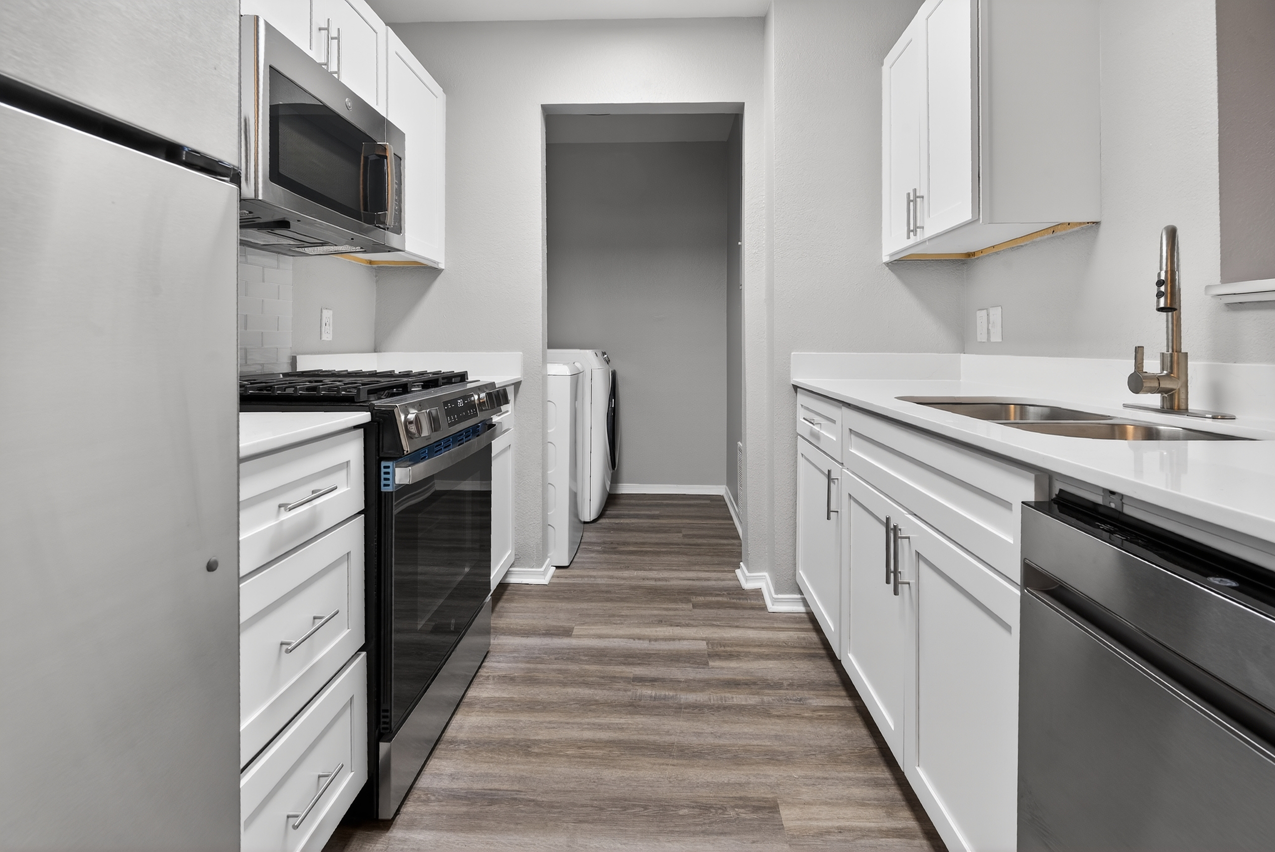 Kitchen with stainless steel appliances and white cabinets