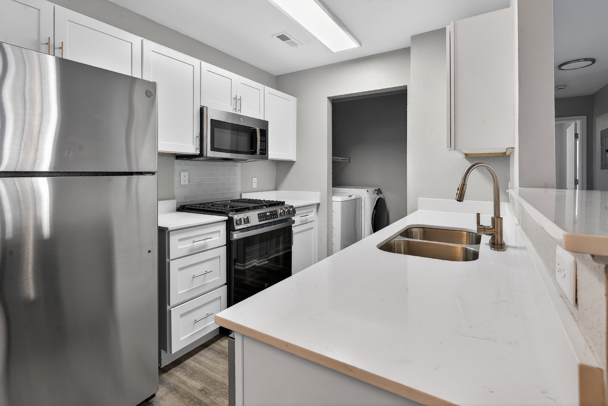 Kitchen with stainless steel appliances and white cabinets