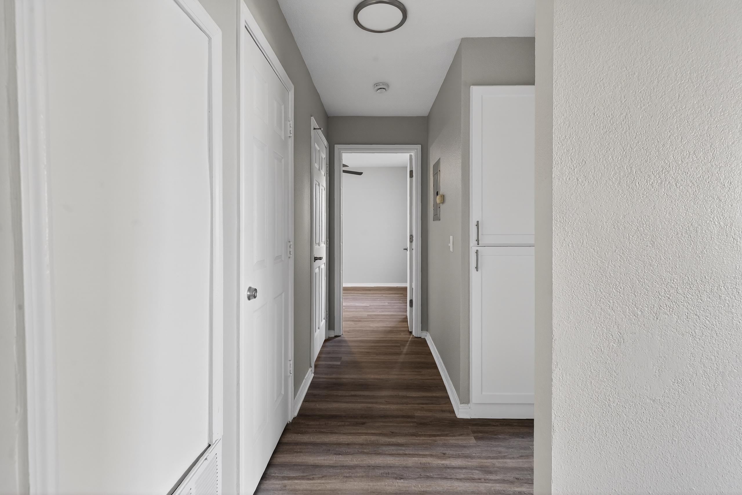 View down hallway into unfurnished bedroom