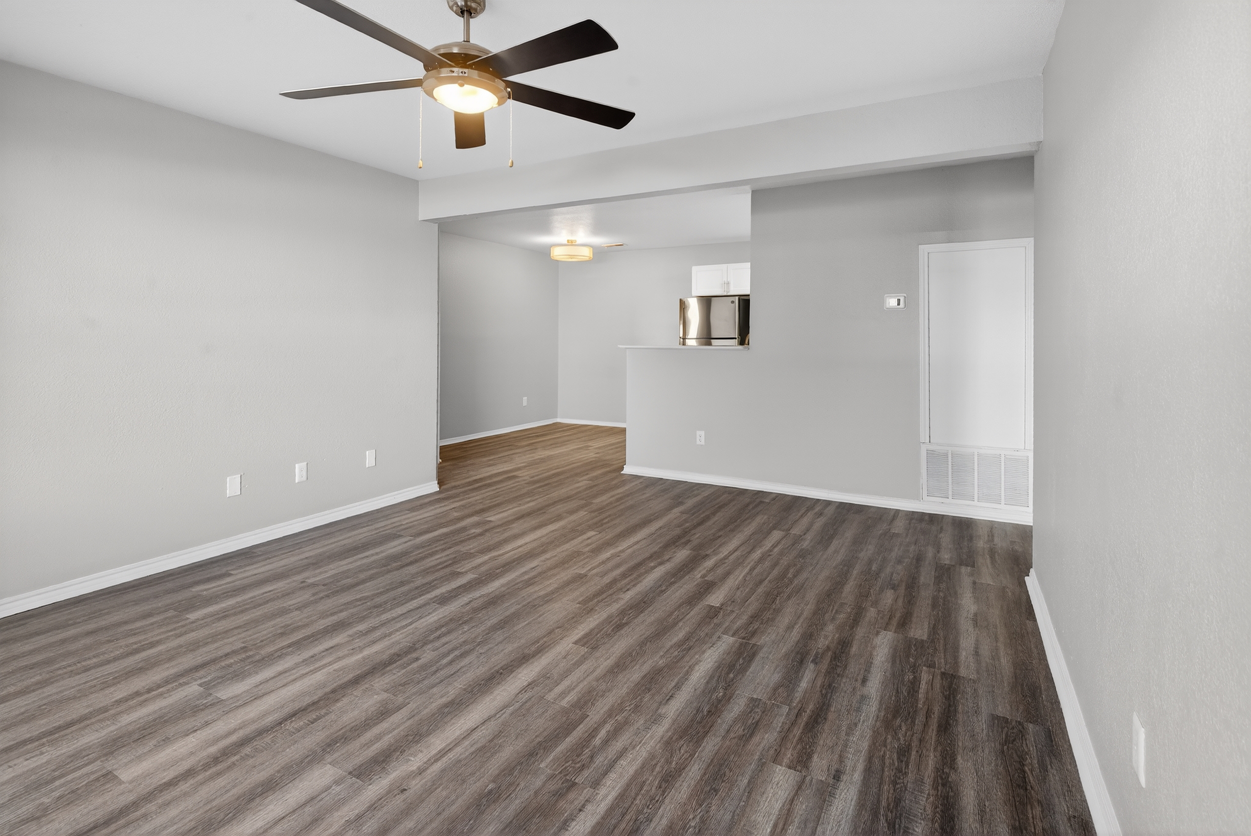 Unfurnished living area with ceiling fan
