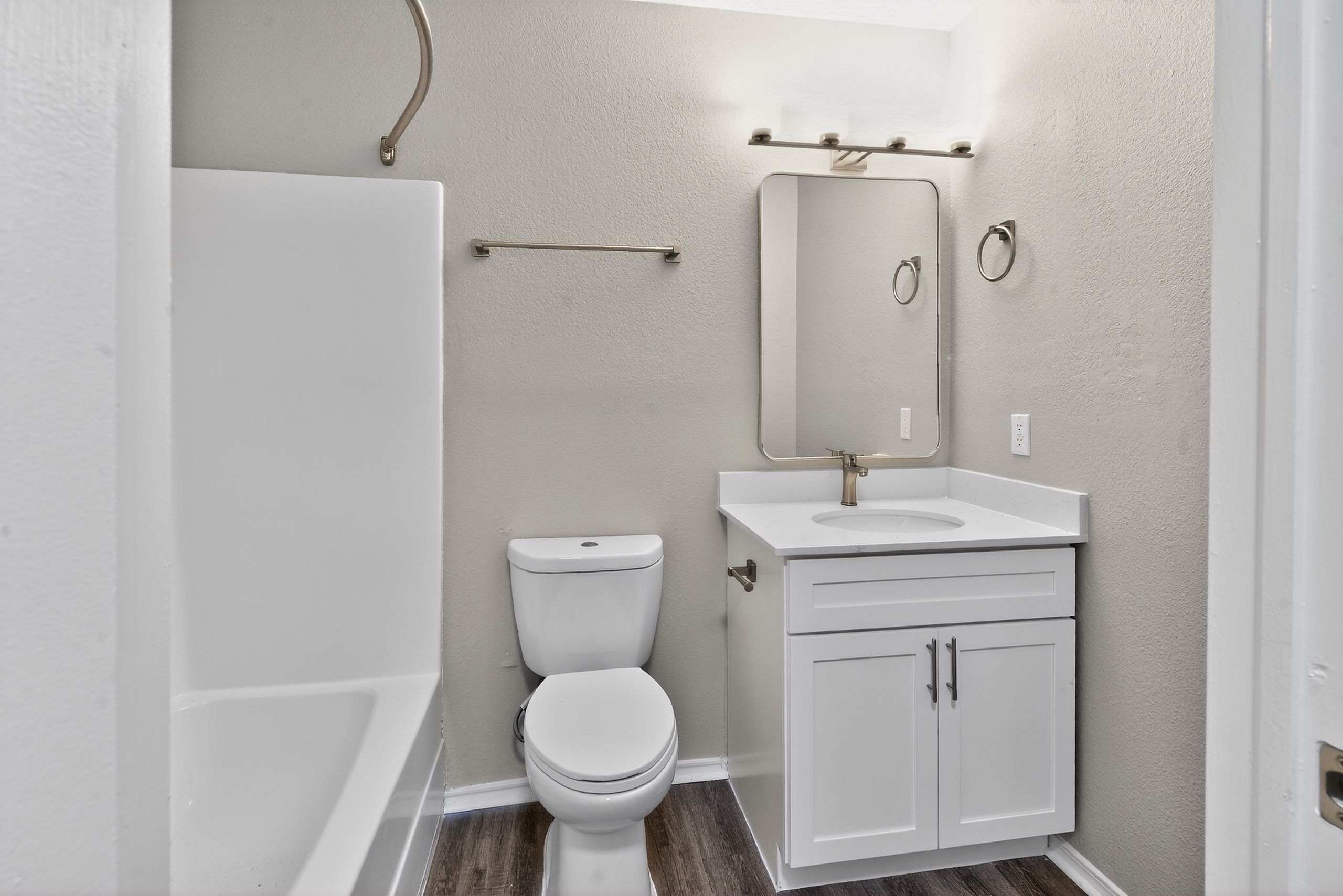 Bathroom with tiled tub and vanity