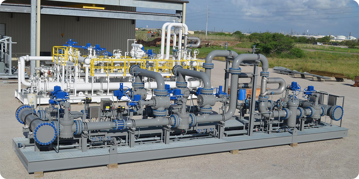 Yellow industrial piping and flow metering skid representing custom measurement infrastructure design