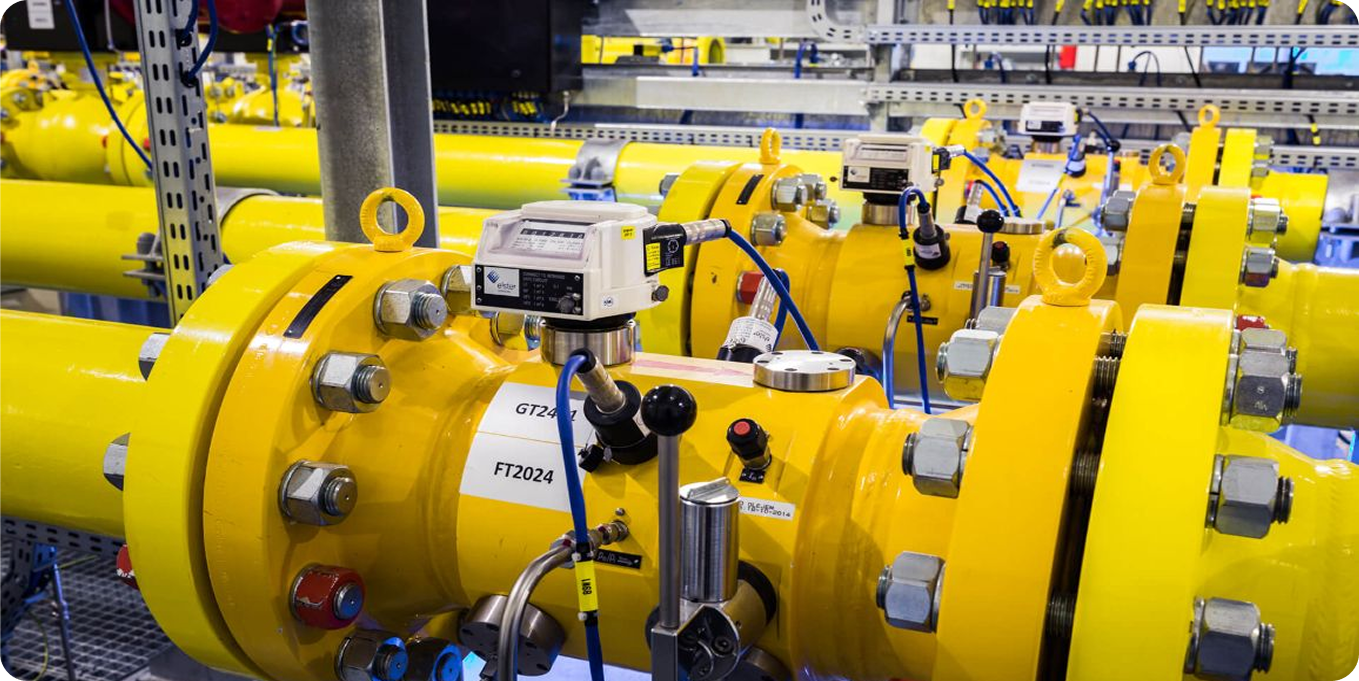 Yellow industrial piping and valves representing independent audits and certification of measurement programs