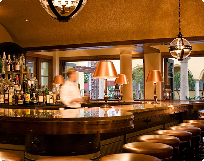 Omni Speakeasy Bar with bartender cleaning a glass