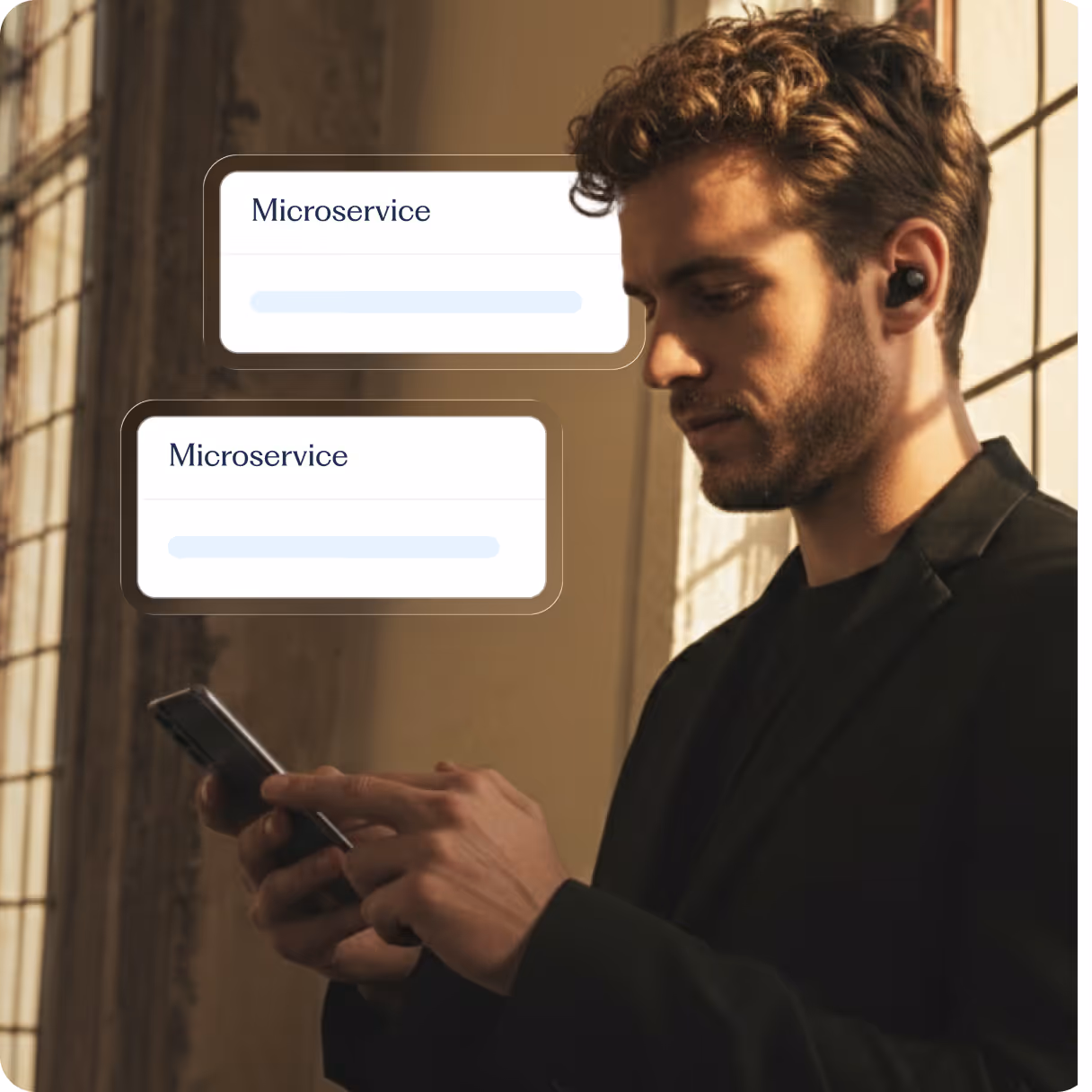 A man standing by a well-lit window checking his phone