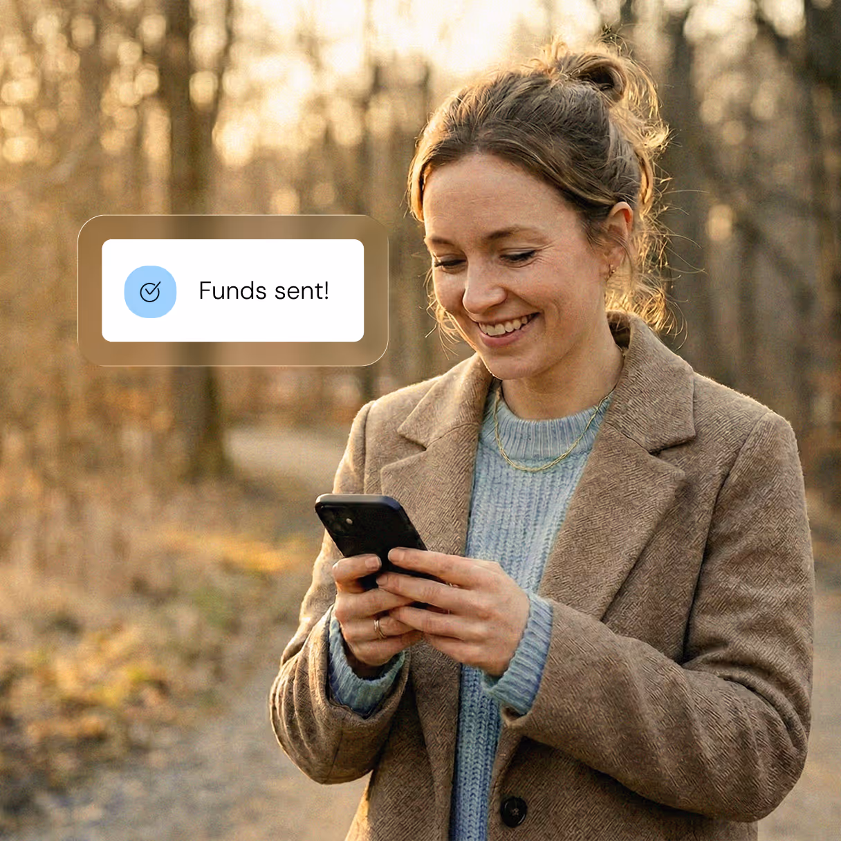 A woman smiling while using her phone