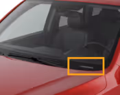 Close-up of a red car's windshield wiper on the driver's side.