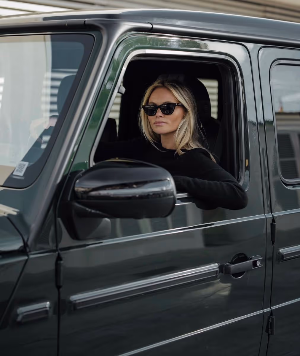 woman sitting in GLS mercedes smiling