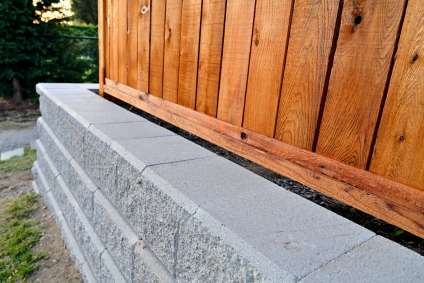Retaining wall under fence