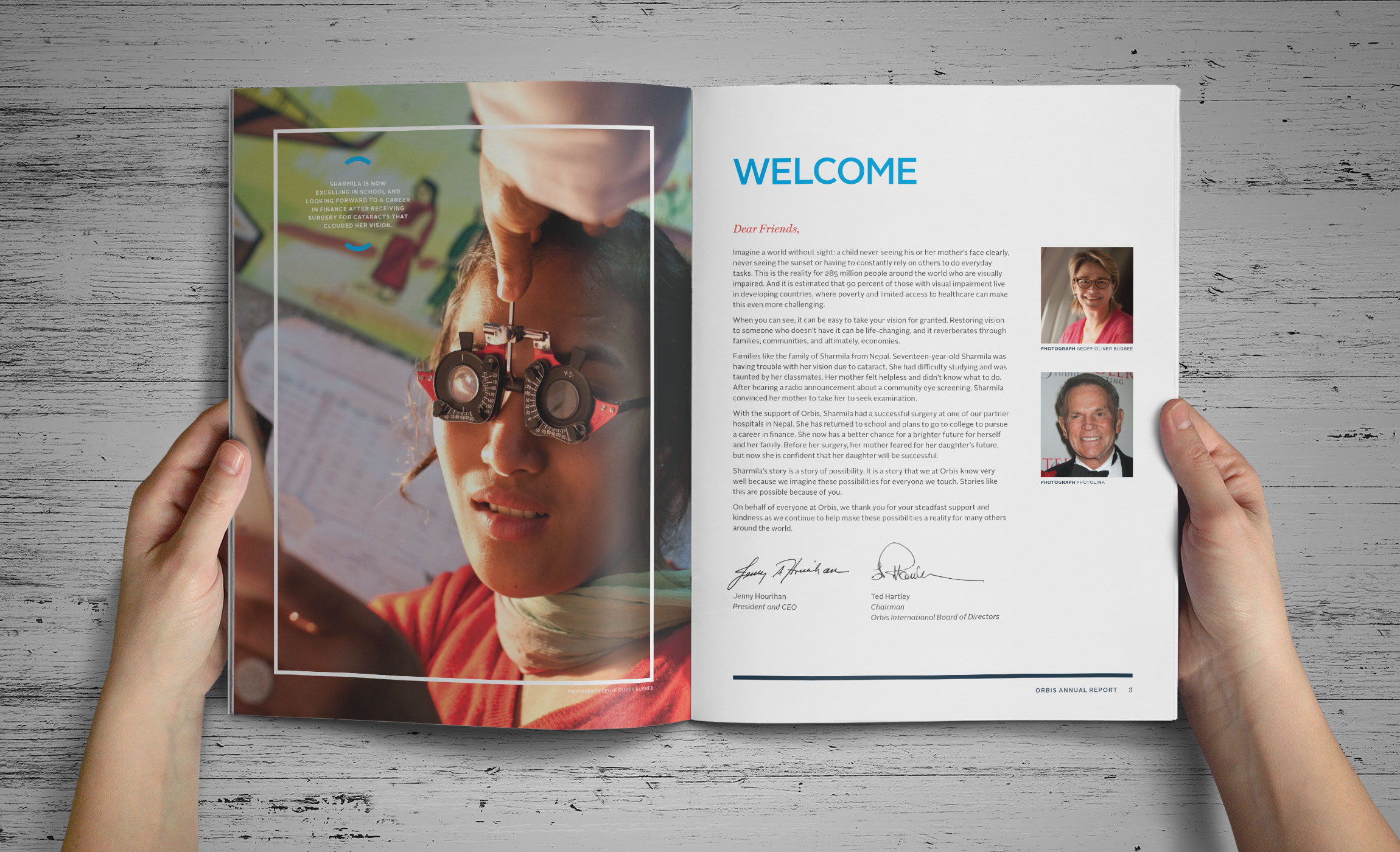 Hands holding Orbis Annual Report inside spread