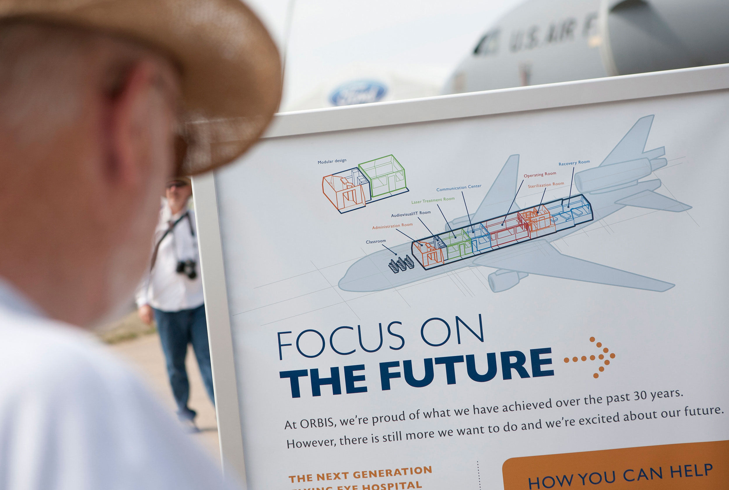 Man looking at Orbis exhibit stand