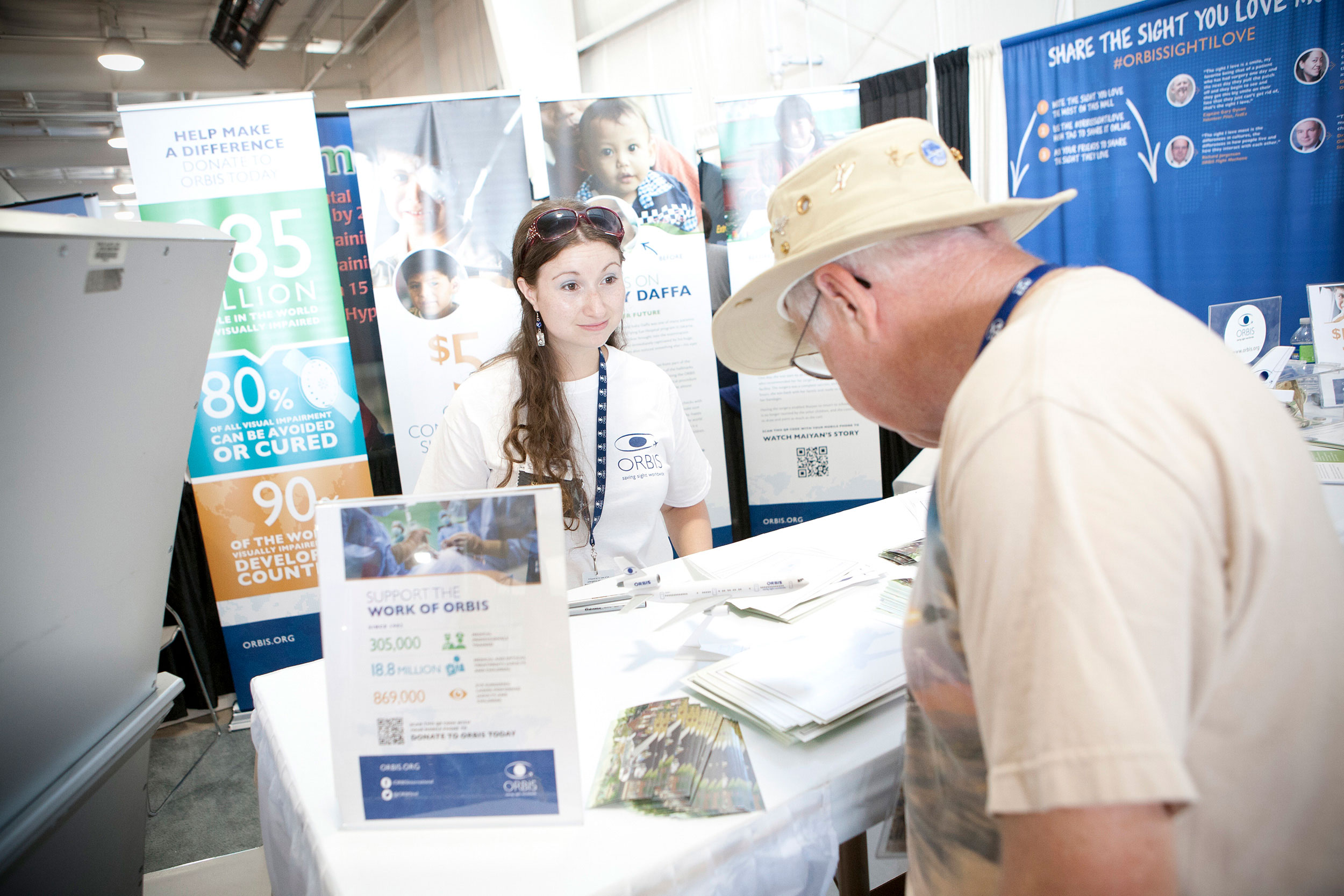attendee interacting with Orbis staff member