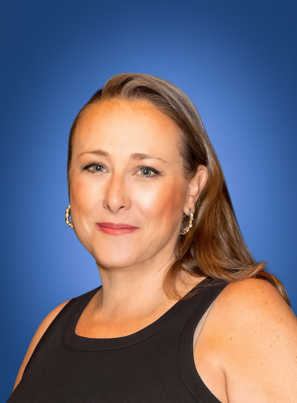 Meghan Dunn staff directory photo smiling against blue background