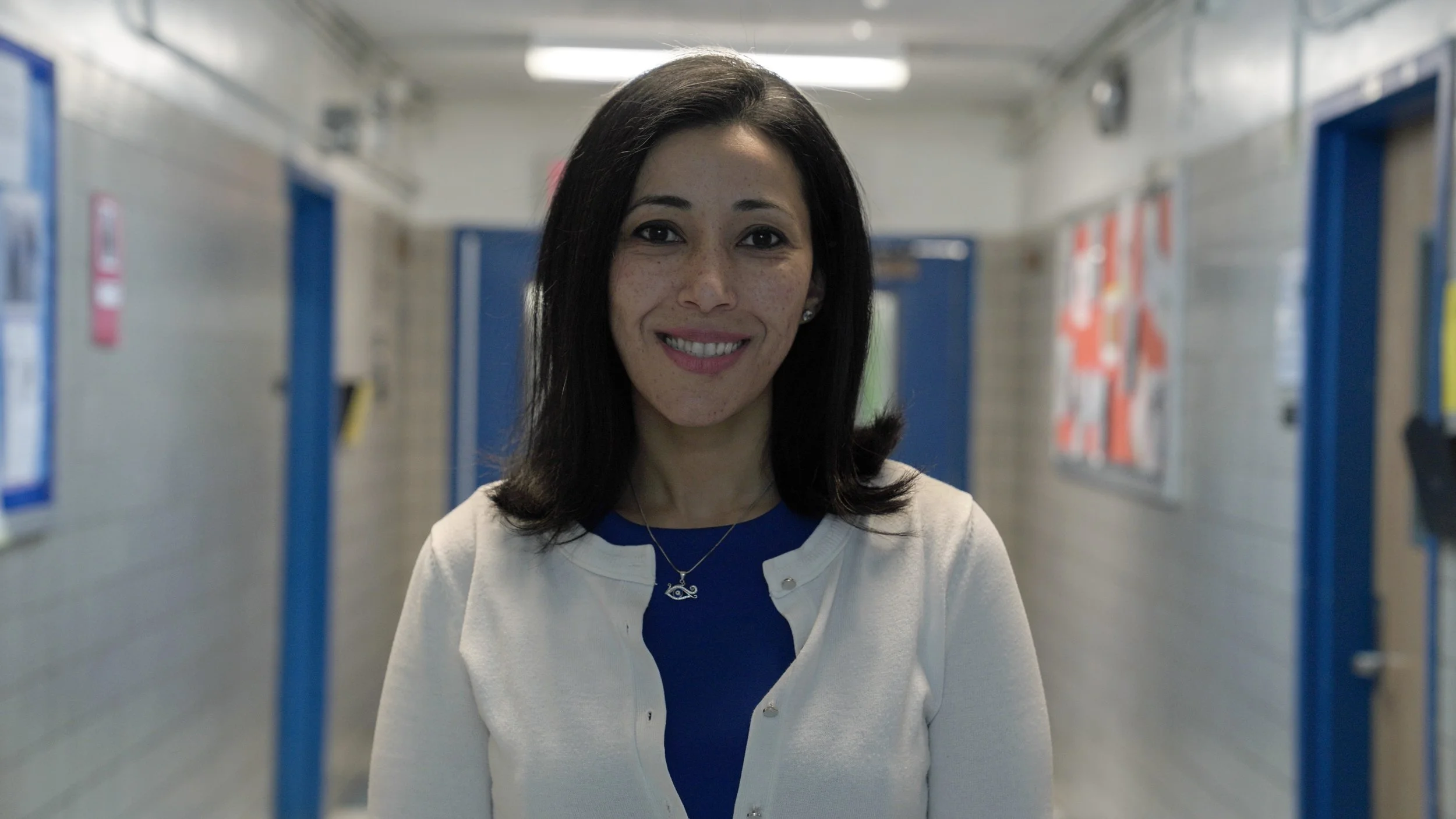 Margaret Moowad smiling in a school hallway
